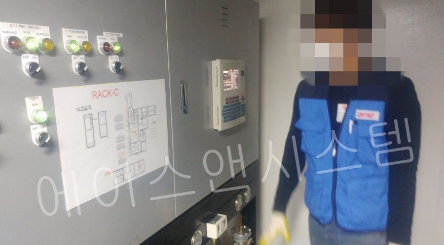 대형 물류센터 냉동창고 컨트롤 패널 도면 점검 중인 에이스앤시스템 작업자
